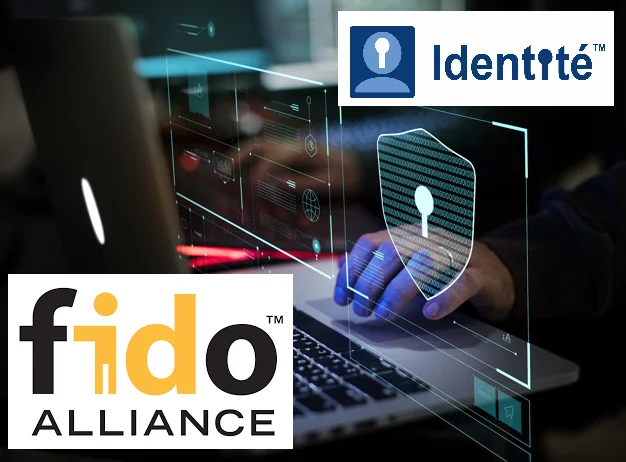 Manos en el teclado de la computadora portátil con símbolos de seguridad digitales superpuestas. Logos para FIDO Alliance y Identité visibles, sugiriendo tema de ciberseguridad.